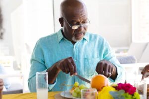 Senior man preparing to eat some fruit